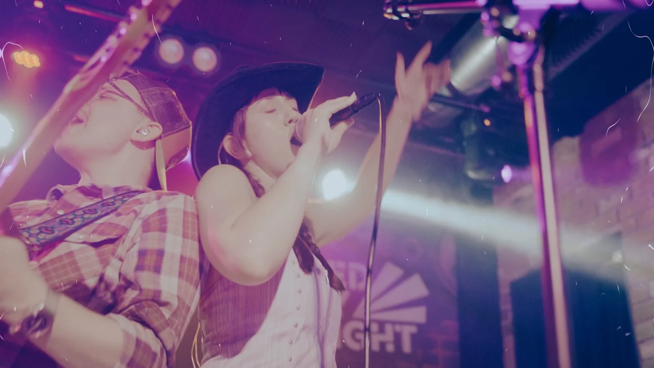 Next Stop Nashville female vocalist reaching out to the audience