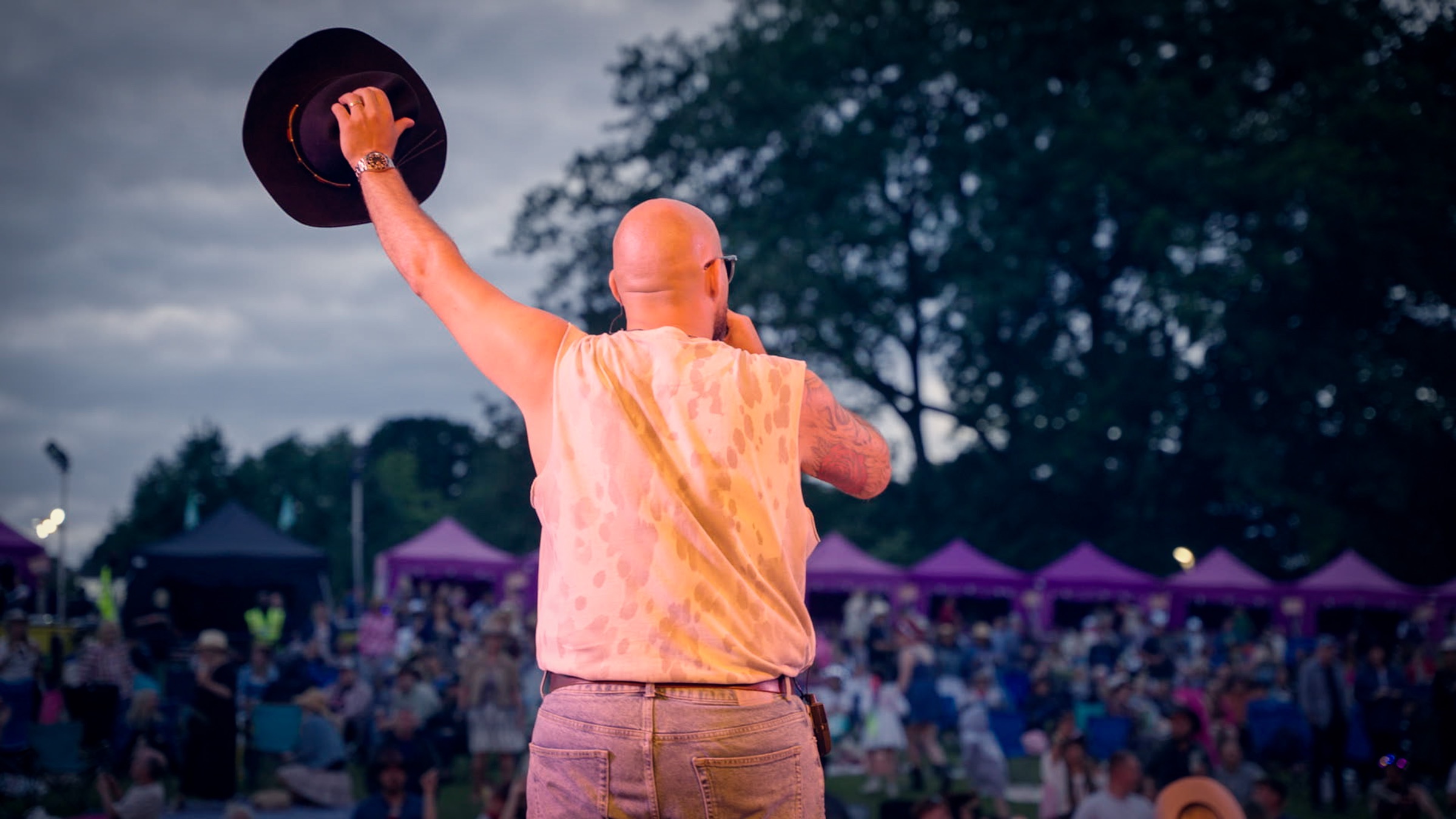 Next Stop Nashville saluting a festival crowd at the end of the show