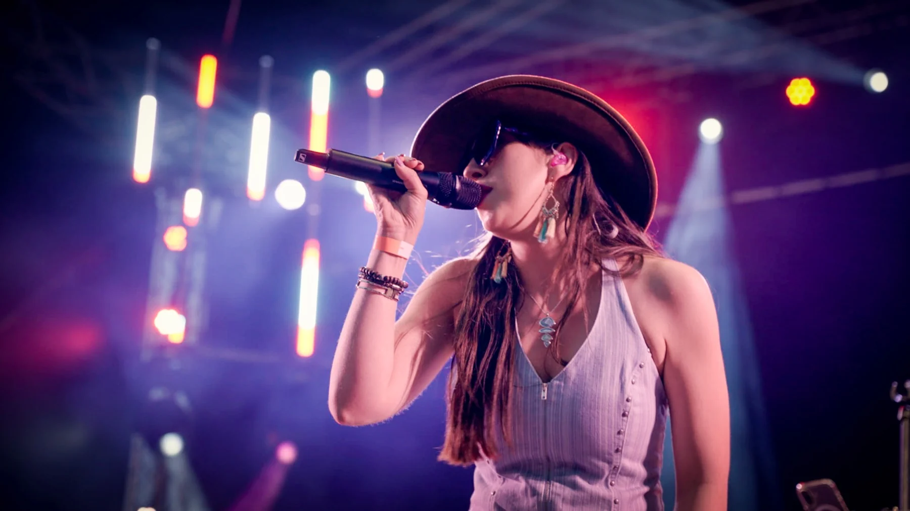 Next Stop Nashville female vocalist singing under festival lights